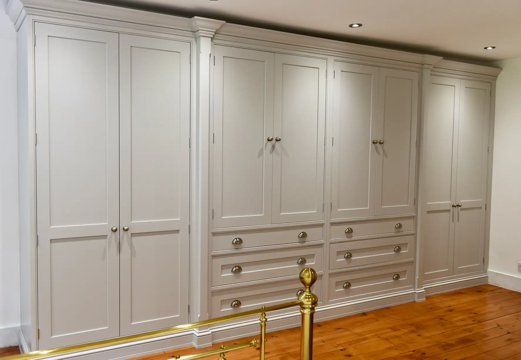 Large bespoke traditional fitted wardrobes with custom drawers.