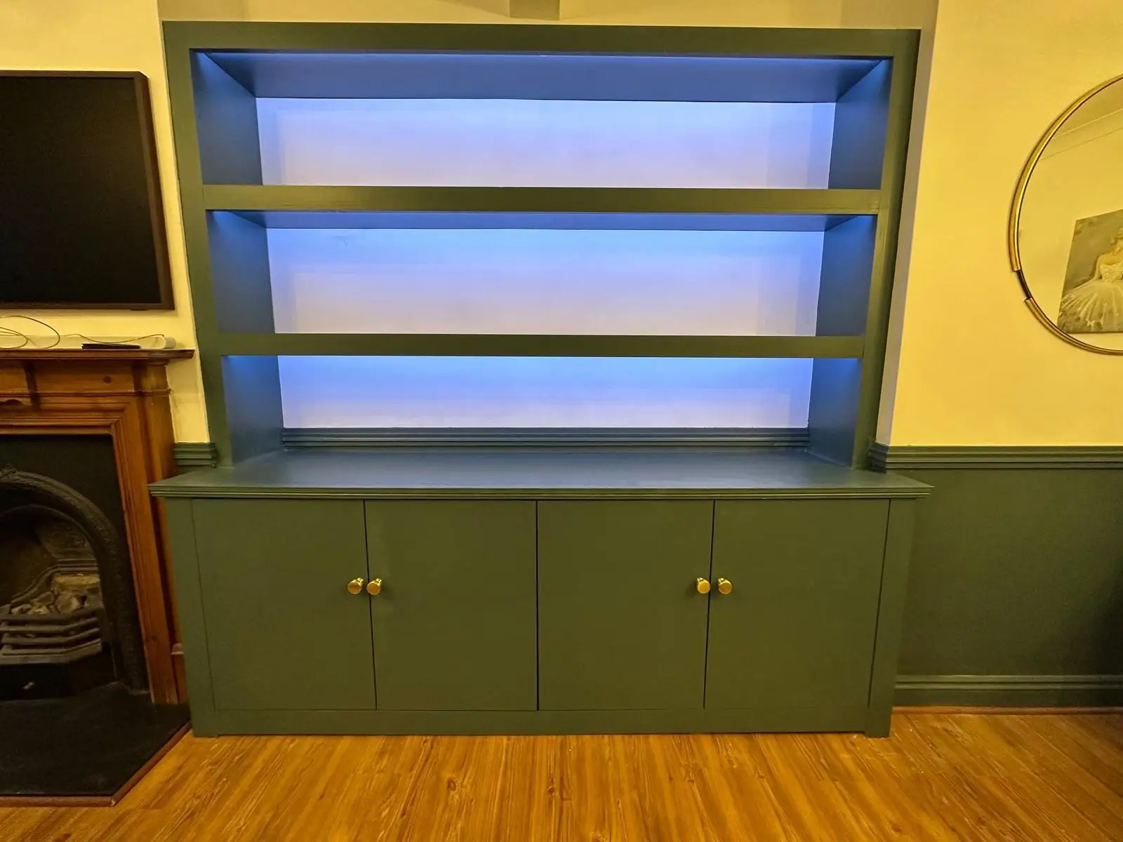 Bespoke custom fitted cabinet with shelves down lighting.