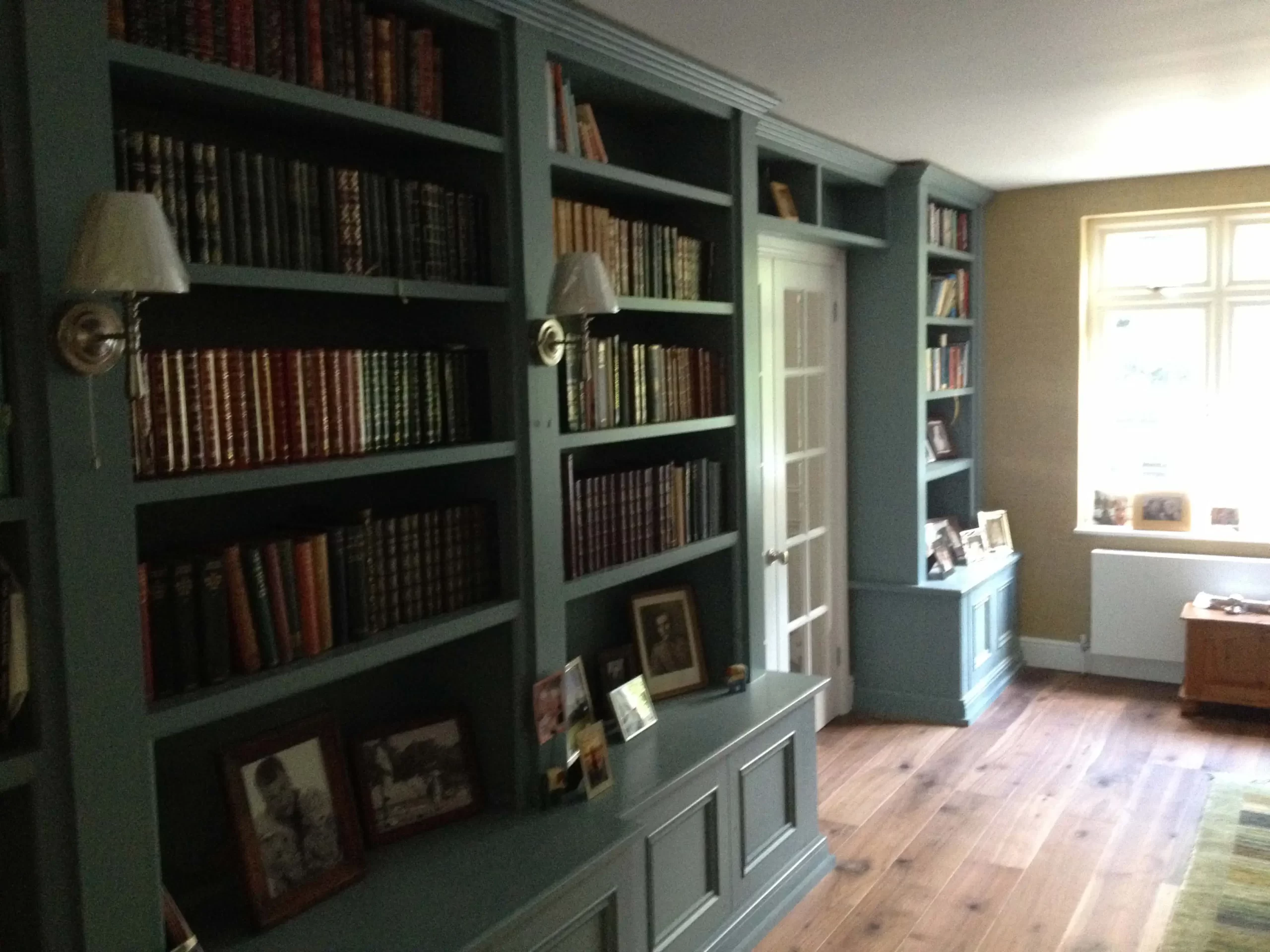 Built in Cabinets with bookcase shelving above displaying books and photos.London.