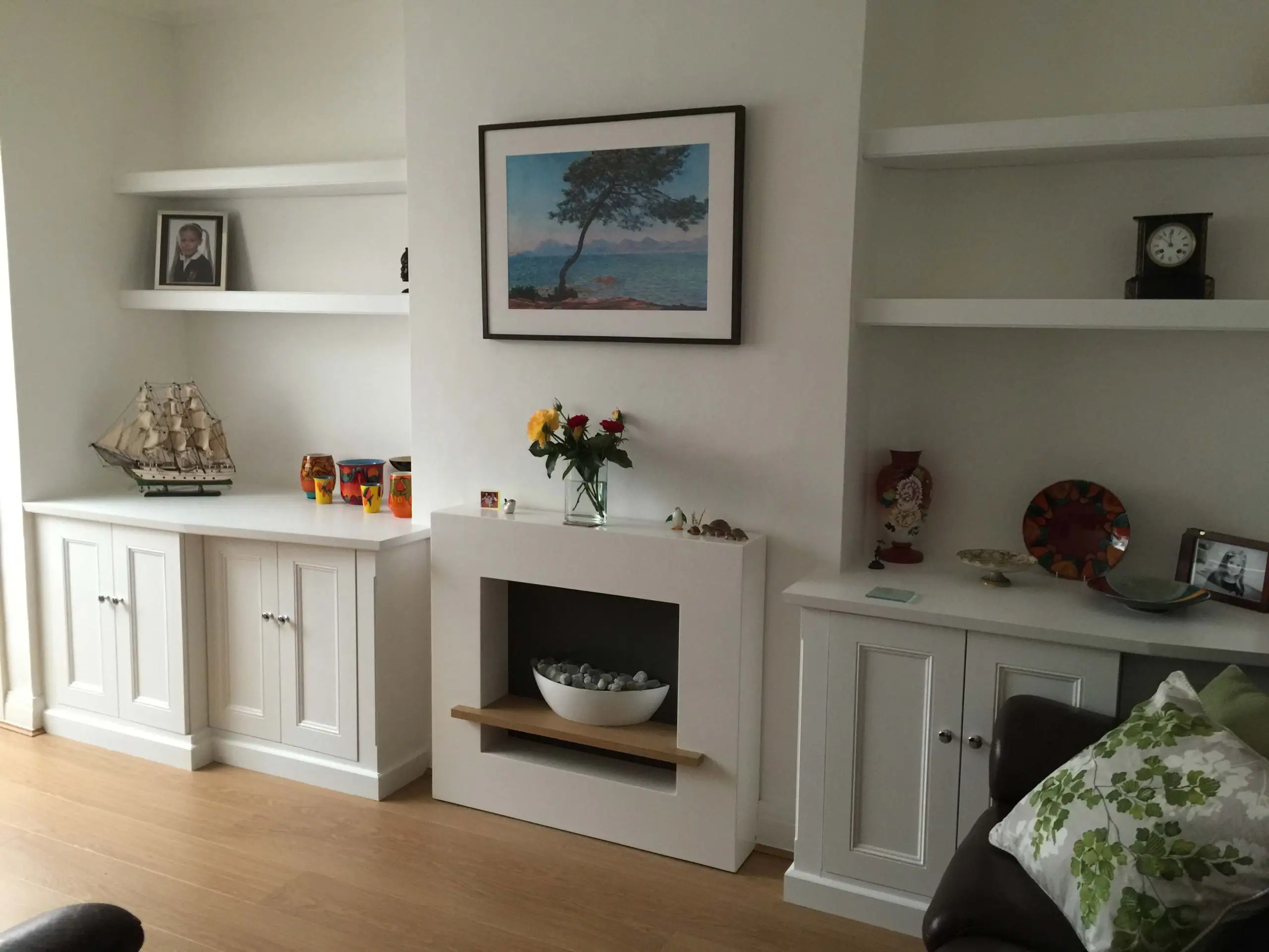 Classic fitted white base cabinets with floating shelves.