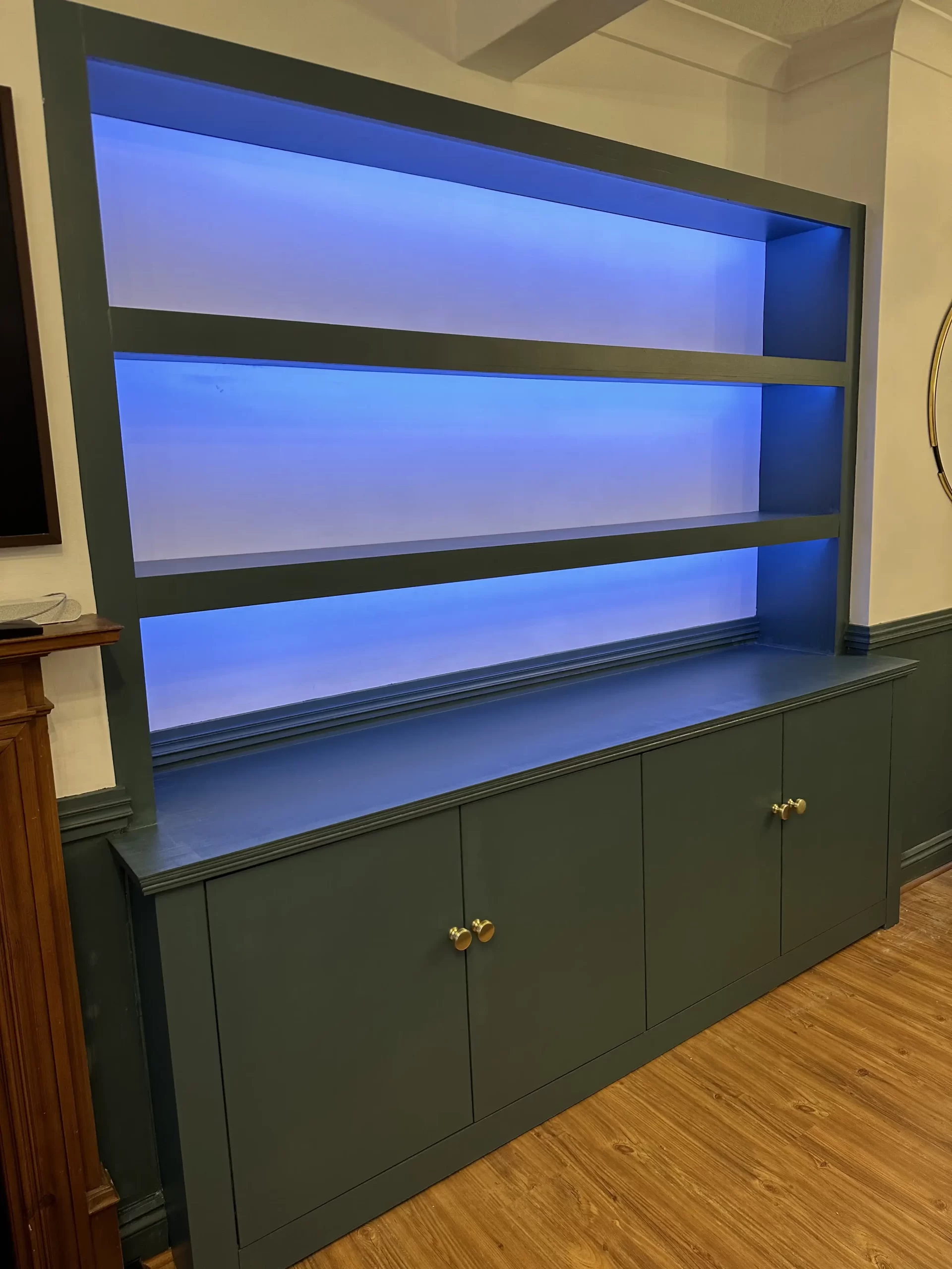 Custom built in base cabinets with shelving and led lighting.