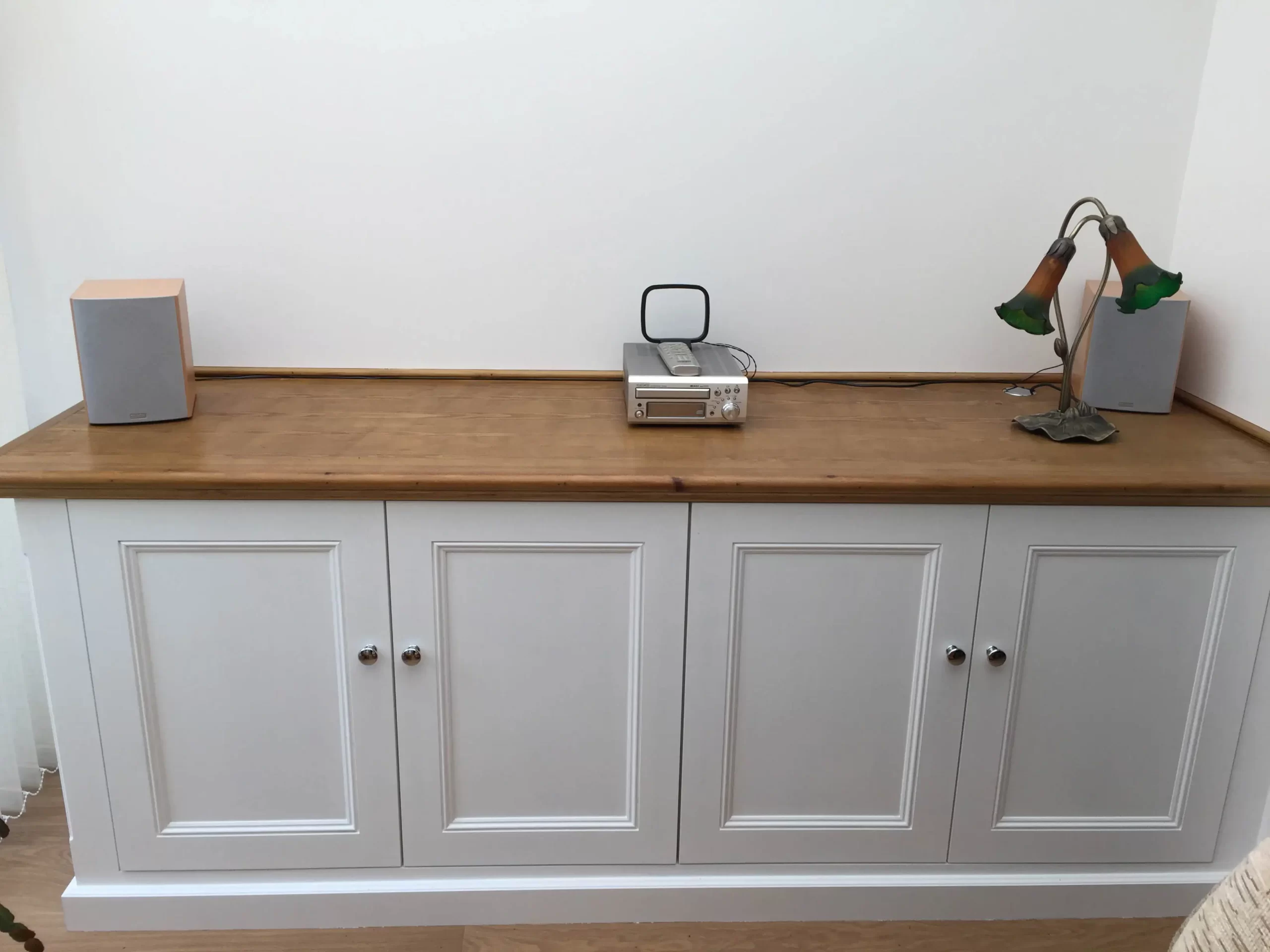 Custom fitted cupboards with shaker style doors, finished in oak decor top.