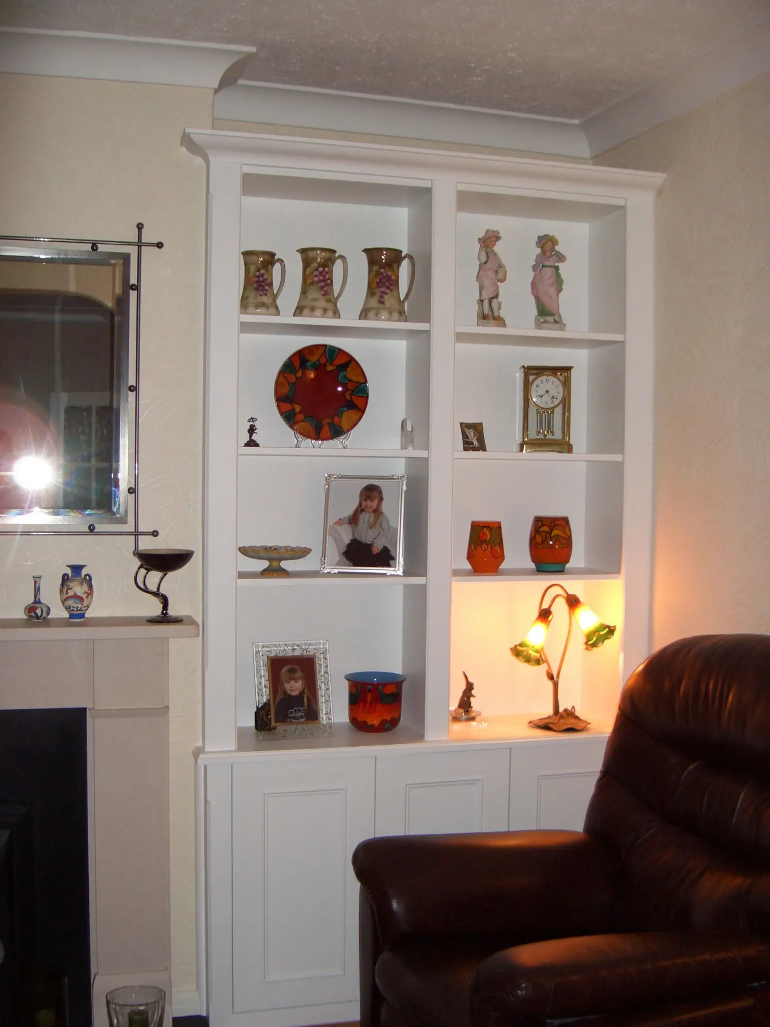 Fitted alcove display unit with upper shelving finished in Farrow & Ball white.